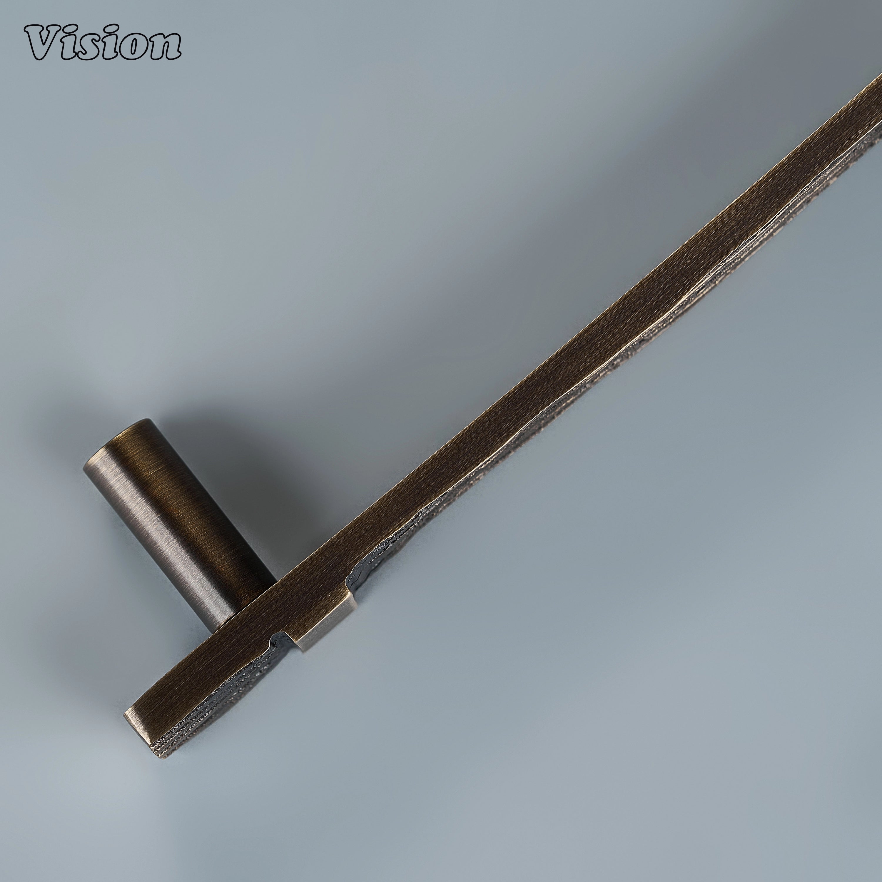 Textured antique bronze sculpted drawer pull with parallel ridges on custom kitchen cabinetry