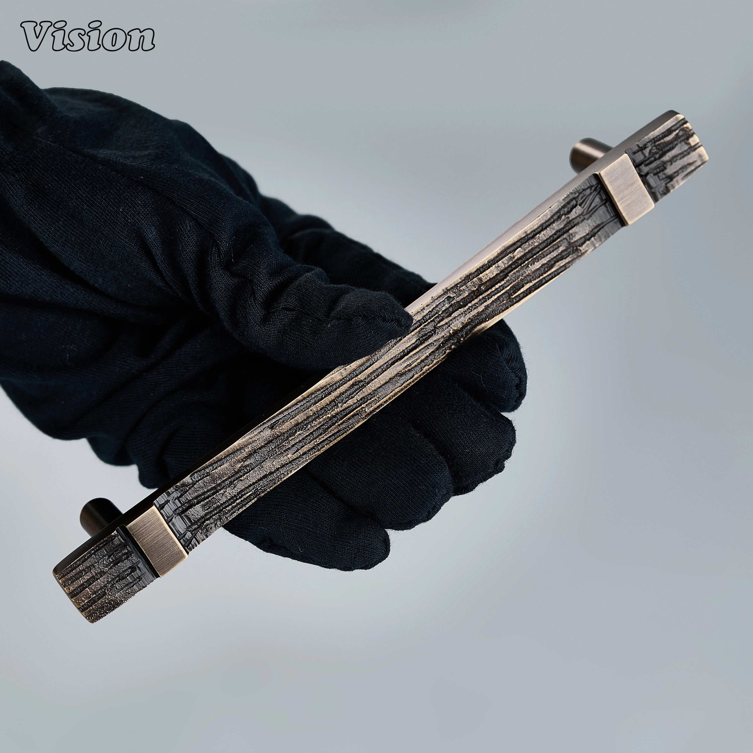 Heavy-duty antique bronze cabinet hardware with sculpted brass carved bar for tall cupboards