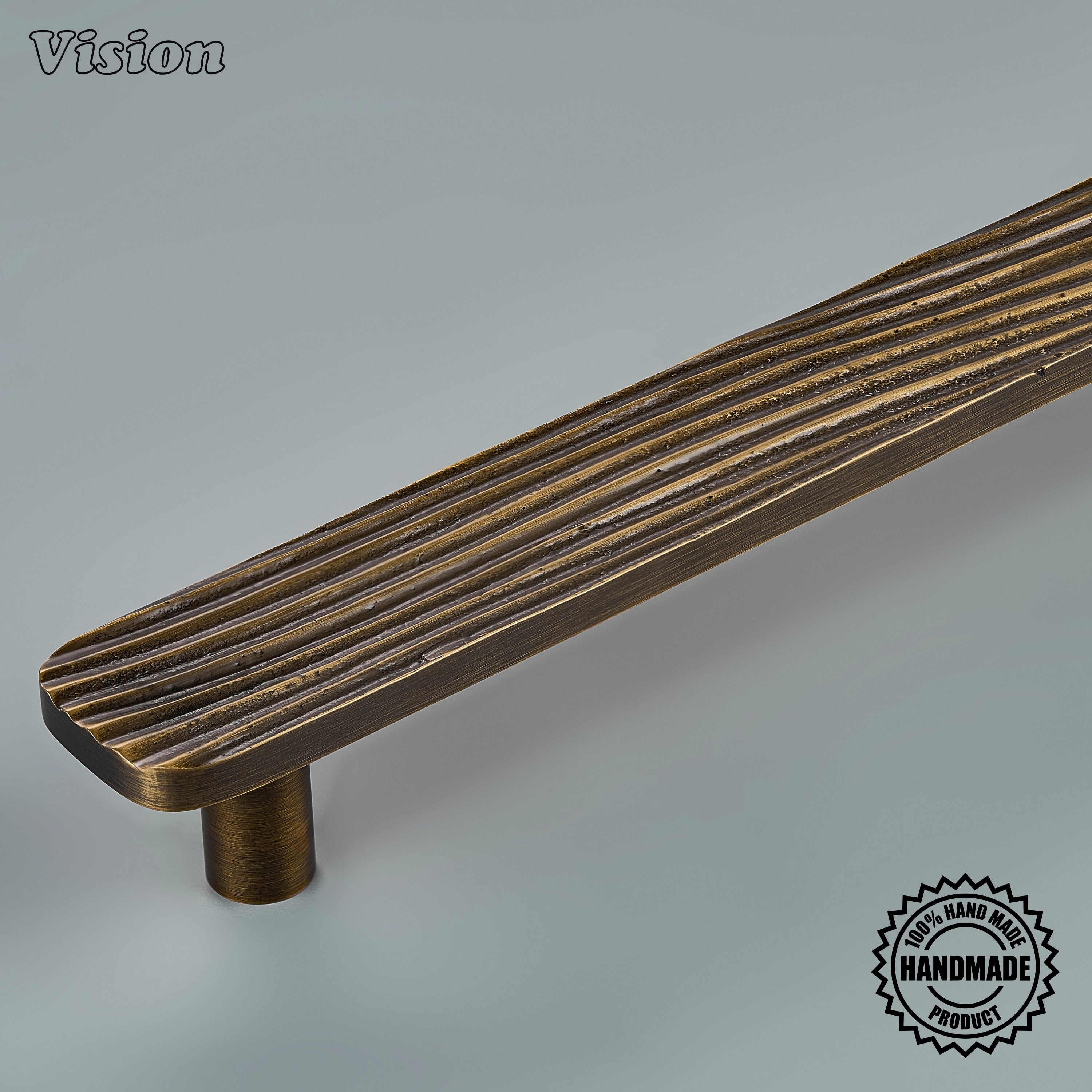 Sculpted antique bronze door handle with parallel grooves mounted on panel-ready refrigerators