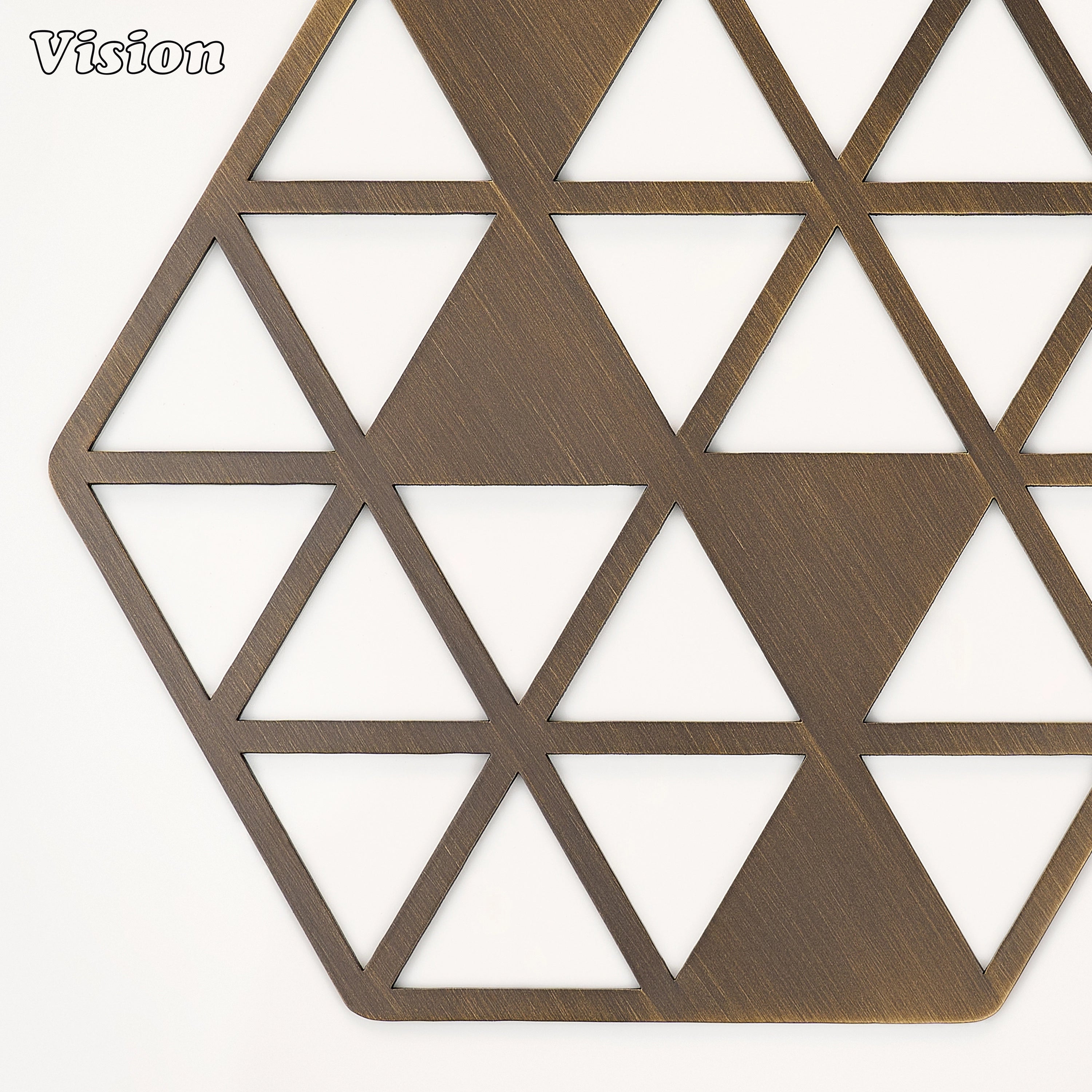 Heavy antique bronze solid brass drink coaster with sharp faceted cutouts on a contemporary office desk