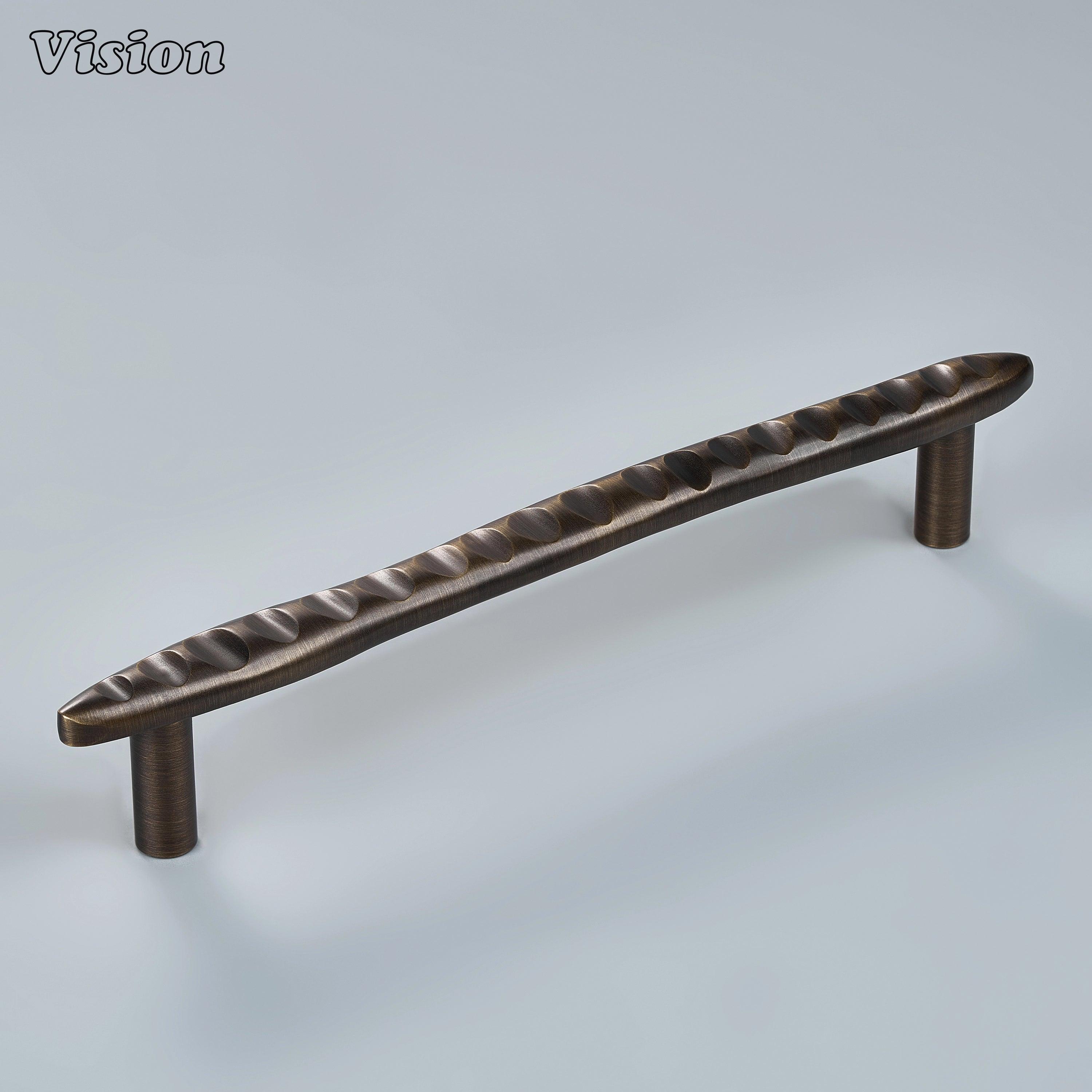 Sculpted antique bronze cabinet handle with organic wave ridges on modern statement drawers
