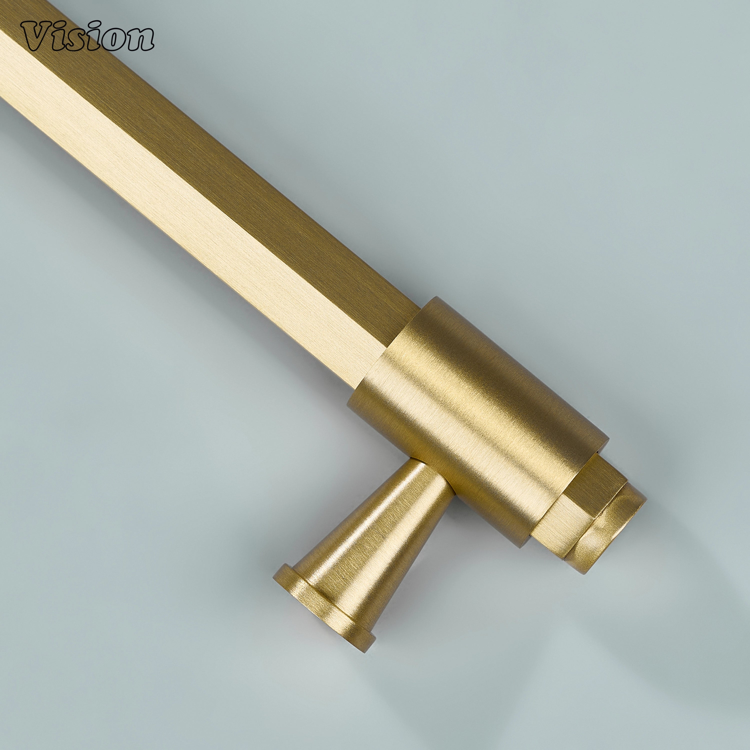 Gold cabinet handle with hexagonal bar profile, circular hardware ends and decorative ring accents for furniture