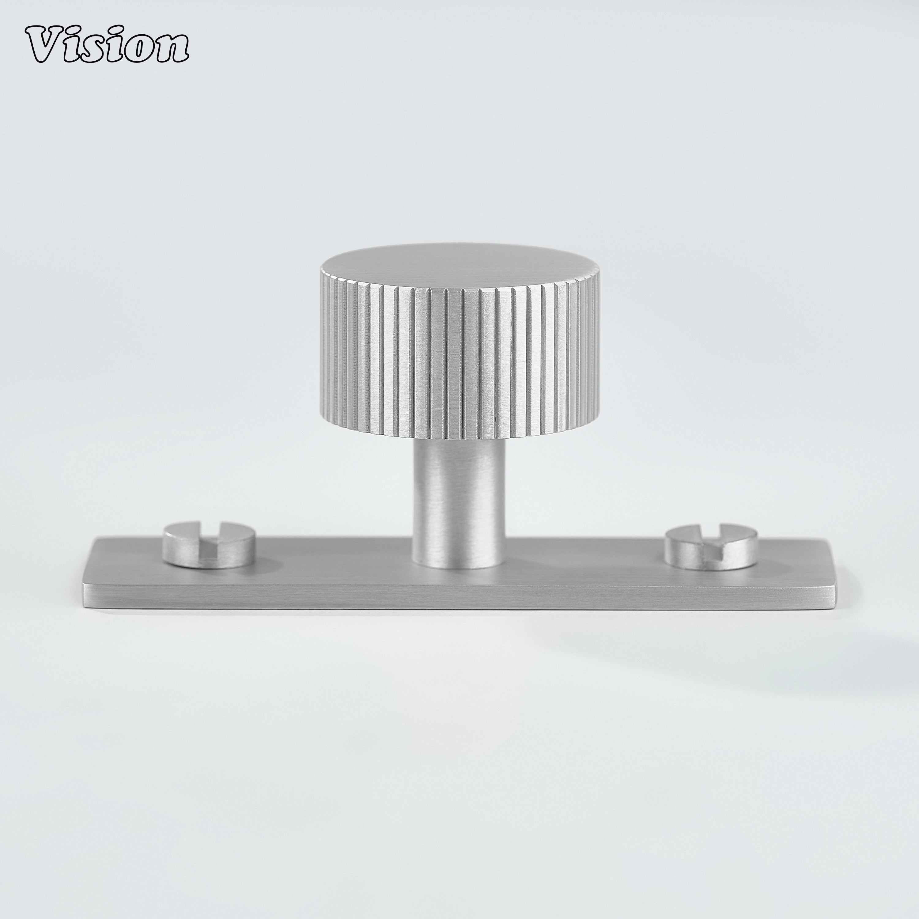Silver knurled cabinet knob with round form and backplate for furniture doors